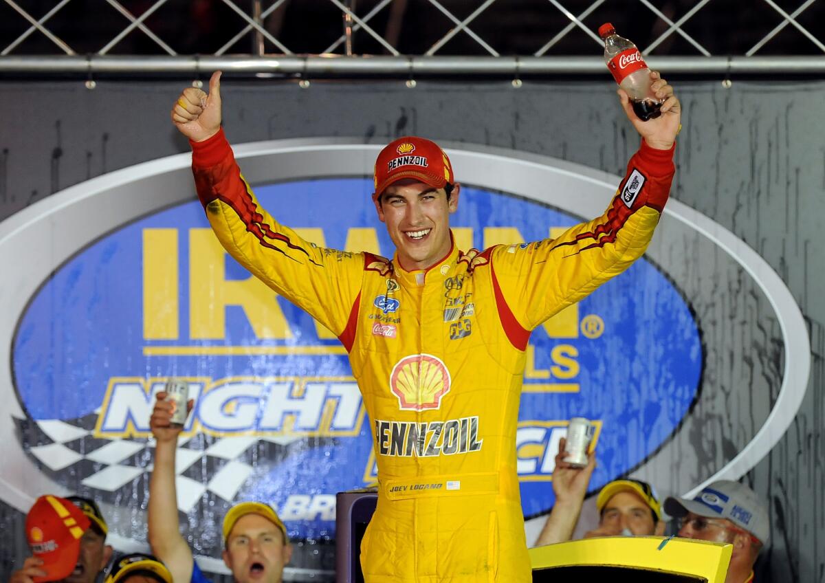 Joey Logano celebrates after winning the NASCAR Sprint Cup Series race Saturday at Bristol Motor Speedway.