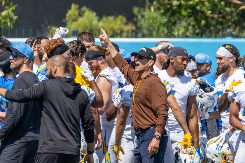 Chargers Head Coach Jim Harbaugh shouts to the team at the end of a mini camp workout