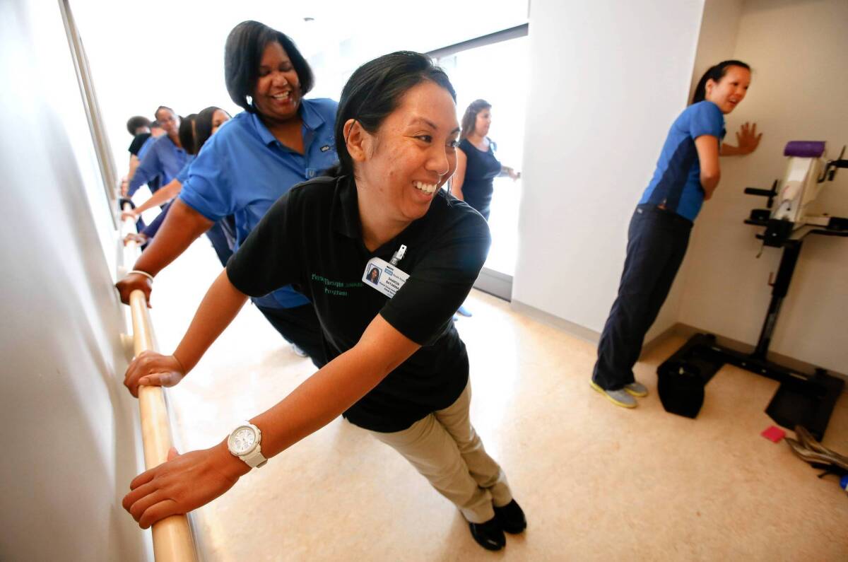 Sharon Batarina, a physcial therapy assistant, foreground, is joined by other staff members of UCLA Health in a Bruin Break workout at Ronald Reagan UCLA Medical Center in Westwood.
