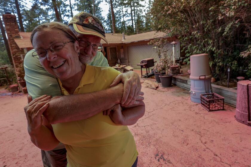 IDYLLWILD, CA JULY 26, 2018 -- Steve and Suzanne Coffer, have lived in Idyllwild for 40 years, at their current home for 24 years, and the Cranston fire marks the first time that a blaze has made it up the canyon into their neighborhood. The Coffers left their home Wednesday afternoon as the fire made its way along Deer Foot Lane. The Coffers spent Thursday surveying their home and nearby, contacting neighbors to let them know whether their homes were damaged. Theyâre grateful all they have to deal with is pink fire retardant. (Irfan Khan / Los Angeles Times)
