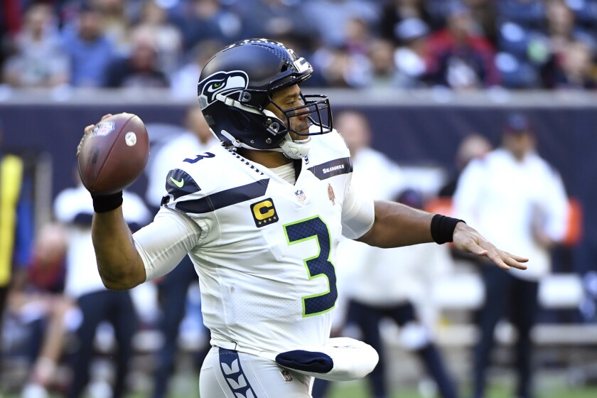 Seattle Seahawks quarterback Russell Wilson (3) throws against the Houston Texans during the first half of an NFL football game, Sunday, Dec. 12, 2021, in Houston. (AP Photo/Justin Rex )