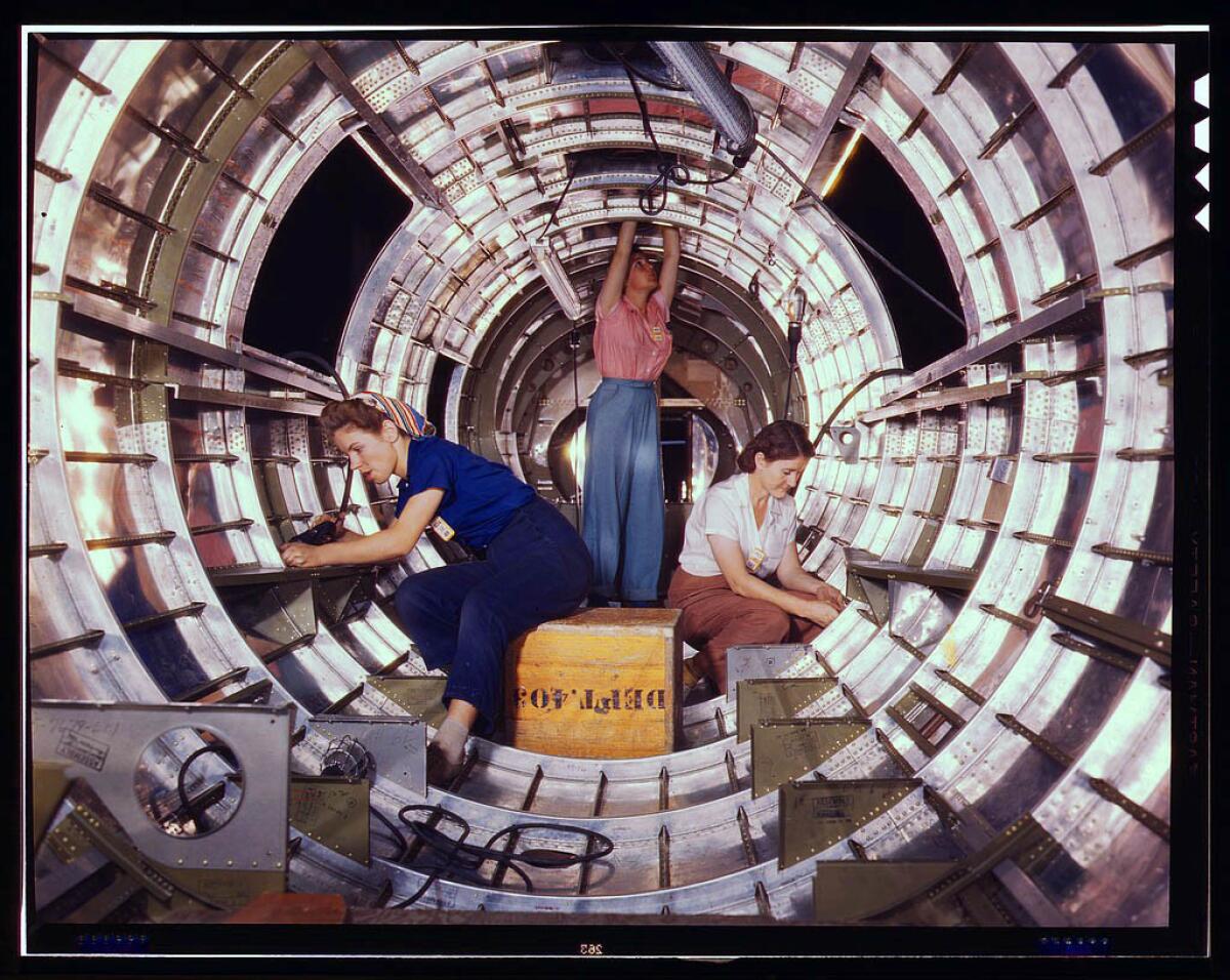 Female workers install fixtures and assemblies to a tail fuselage section of a B-17 bomber at the Douglas Aircraft Co. plant in Long Beach in October 1942.