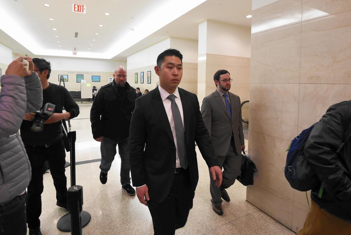 New York Police Officer Peter Liang, center, arrives at a courtroom in Brooklyn on Jan. 20. He faces up to 15 years in prison if convicted of second-degree manslaughter.
