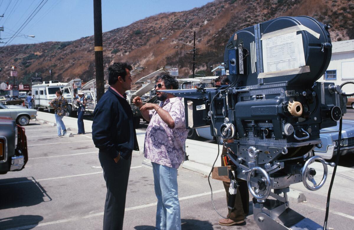James Garner speaks with director Bernard L. Kowalski on set during the filming of an episode of "The Rockford Files."