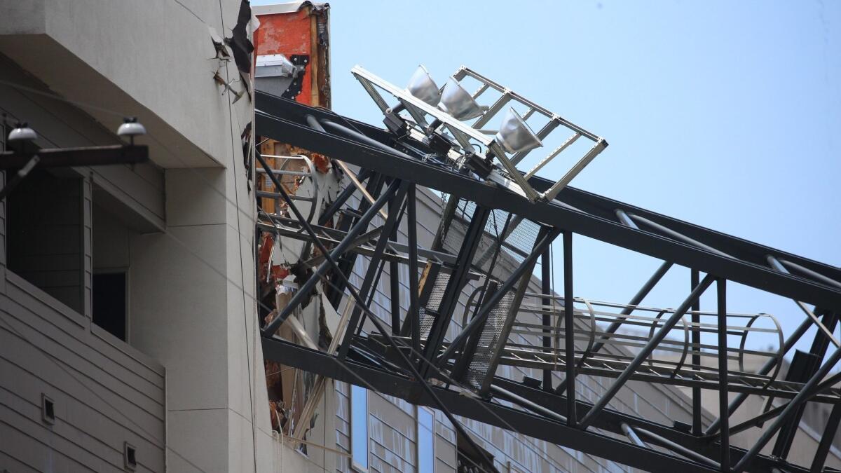 The scene after a crane collapsed onto a five-story building in Dallas.