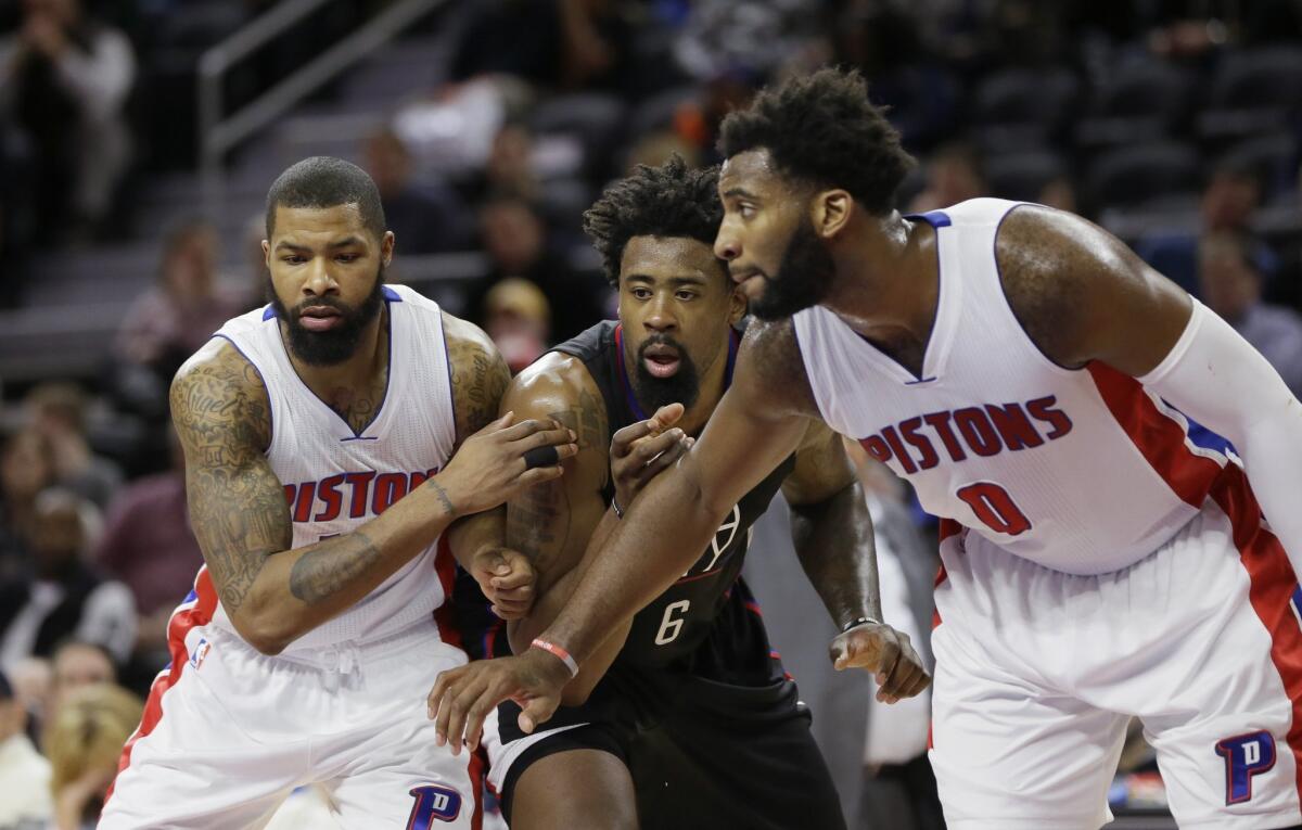 Detroit's Marcus Morris, left, and Andre Drummond (0) try blocking out Clippers' DeAndre Jordan on Monday night.