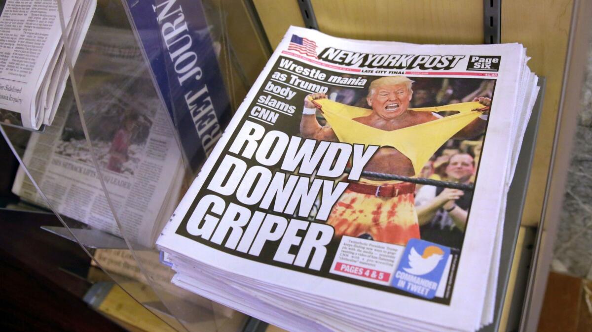 Copies of the New York Post with an illustration of President Trump as a professional wrestler are displayed at a newsstand in New York City on July 3, 2017.