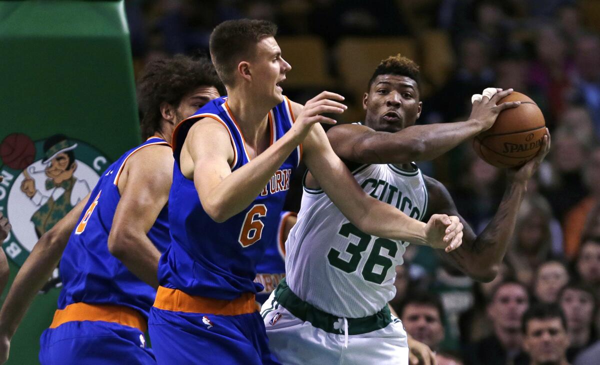 New York Knicks forward Kristaps Porzingis pressures Boston Celtics guard Marcus Smart during the first quarter of a game on Oct. 22.