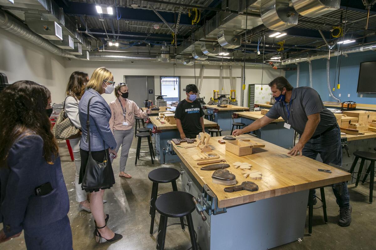 Mike Henderson, right, shows off the new wood shop at Marine View Middle School in Huntington Beach.  