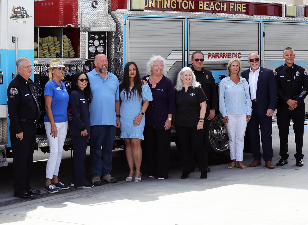 Huntington Beach Mayor Gracey Van Der Mark, center and Mayor Pro Tem Pat Burns pose for pictures with local dignitaries.