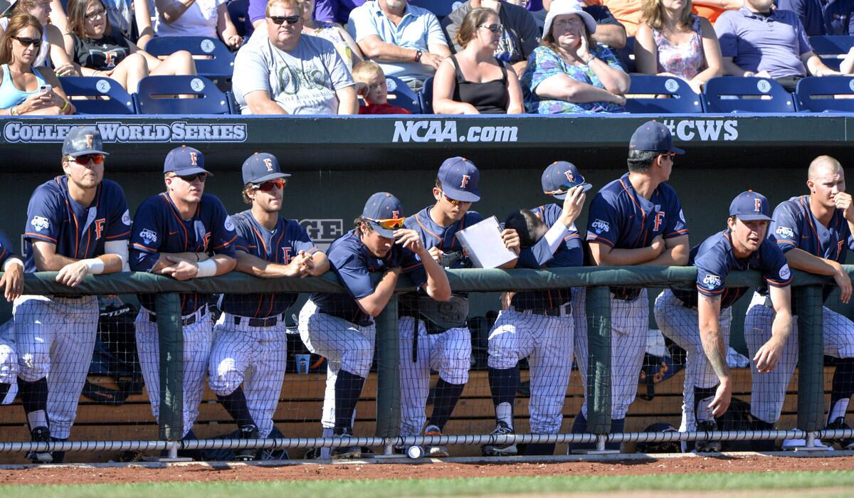 Cal State Fullerton players stand in the dugout in the ninth inning of the NCAA College World Series baseball elimination game against LSU on Tuesday. LSU won, 5-3, ending Cal State Fullerton's season.
