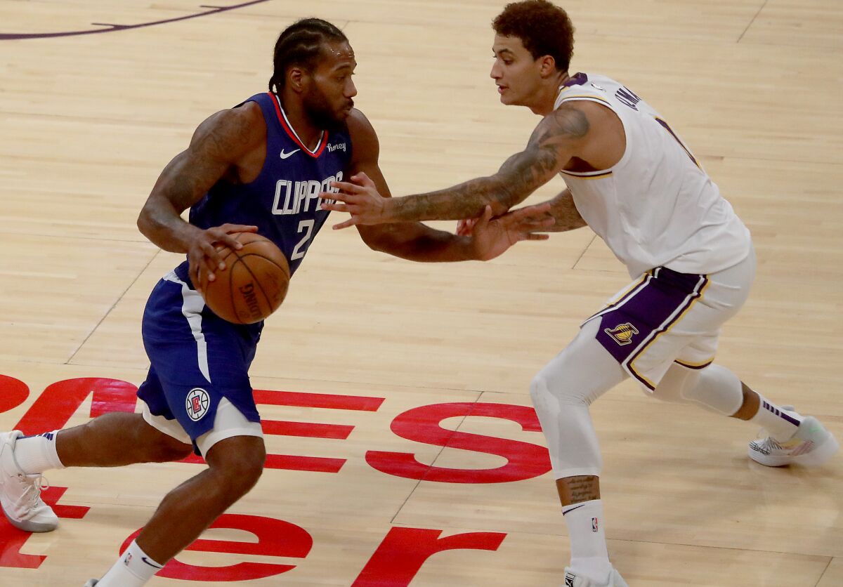 Clippers forward Kawhi Leonard drives to the basket against Lakers forward Kyle Kuzma.