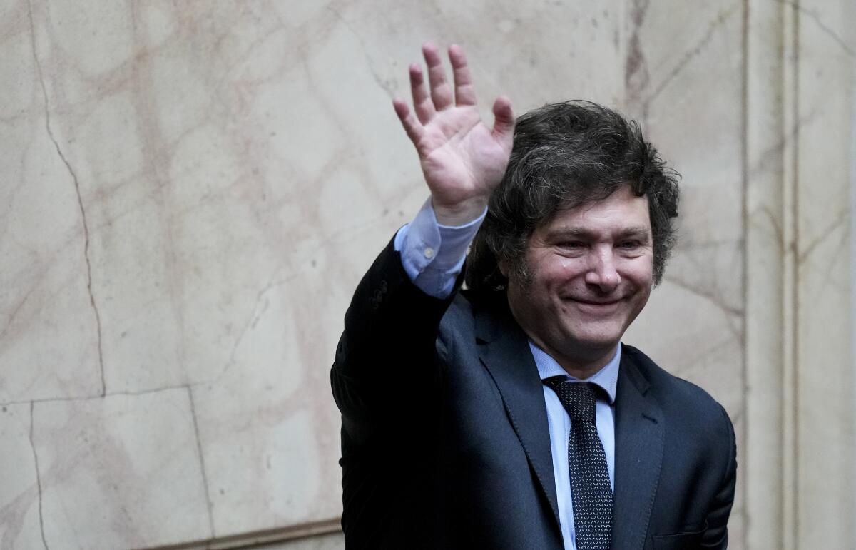 President-elect Javier Milei waves during a joint session of Congress to officially declare him and his running mate winners of the presidential runoff election, in Buenos Aires, Argentina, Wednesday, Nov. 29, 2023. (AP Photo/Natacha Pisarenko)