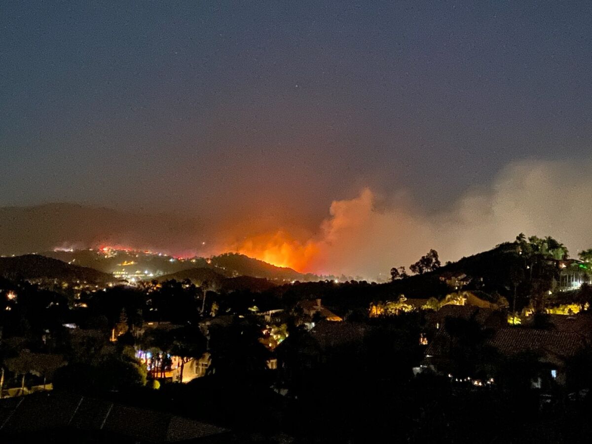 A fire burns Wednesday night in Rancho San Diego