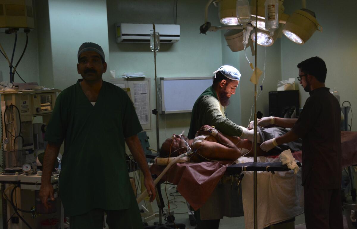Pakistani doctors treat a villager Nov. 23 at a hospital in Muzaffarabad, capital of Pakistani Kashmir.