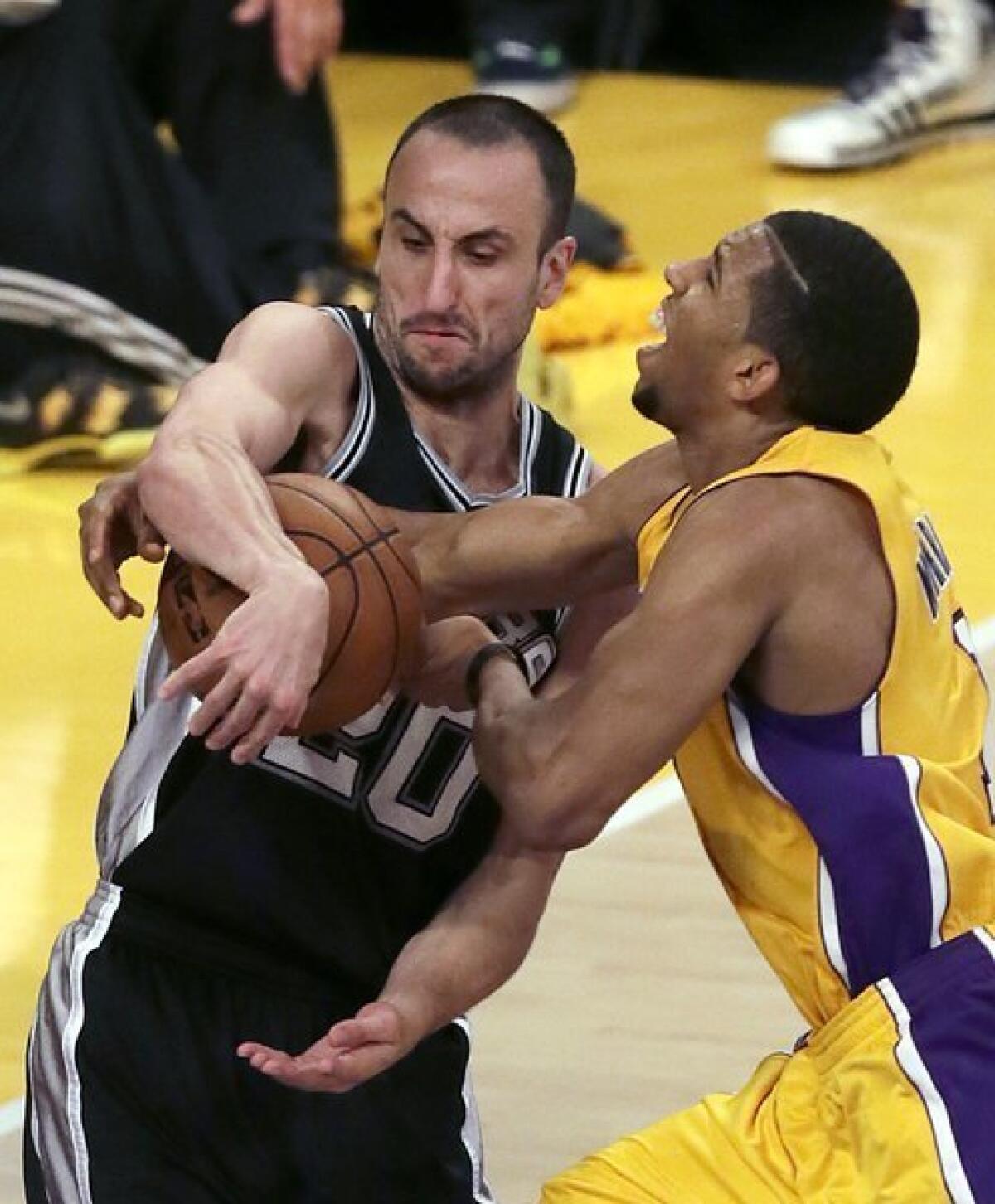 Lakers point guard Darius Morris, who had 24 points, is tied up by Spurs guard Manu Ginobili on a drive in the second half Friday night.