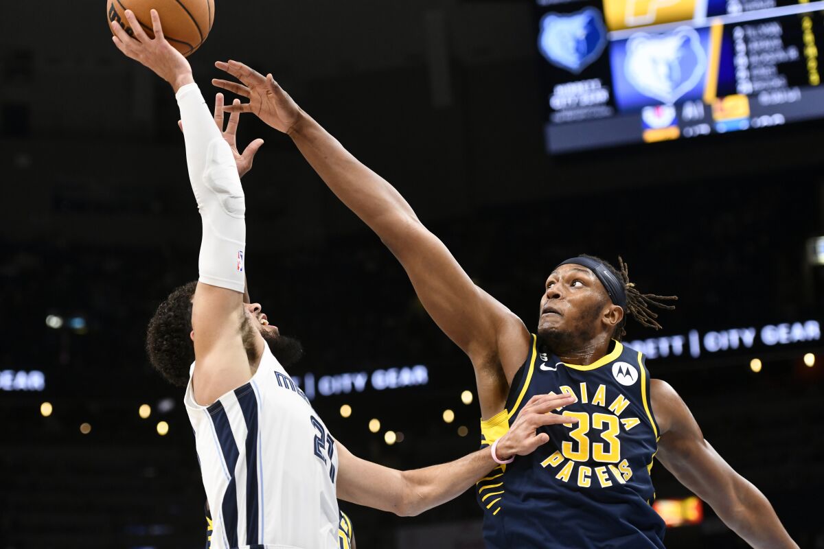 Indiana Pacers center Myles Turner (33) defends against Memphis Grizzlies guard Tyus Jones, left, in the first half of an NBA basketball game Sunday, Jan. 29, 2023, in Memphis, Tenn. (AP Photo/Brandon Dill)
