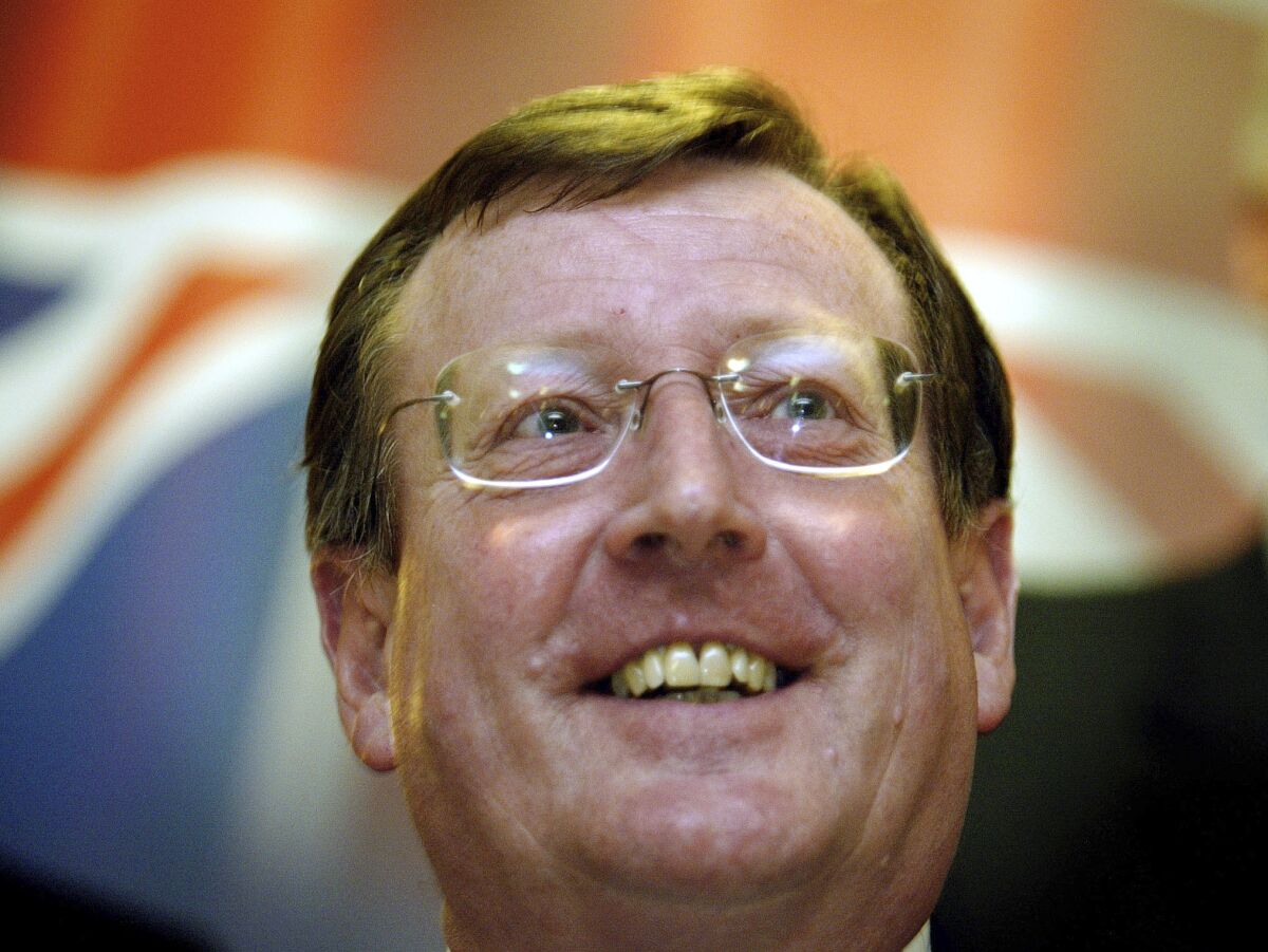 FILE - A delighted Ulster Unionist Party leader David Trimble speaks to the media at a hotel in Belfast, Northern Ireland, June 16, 2003, after winning a crucial vote with his party on its continued support for the Irish peace process. David Trimble, a former Northern Ireland first minister who won the Nobel Peace Prize for being a key architect of the Good Friday Agreement that ended decades of conflict, has died, the Ulster Unionist Party said Monday July 25, 2022. He was 77. (AP Photo/Peter Morrison, File)