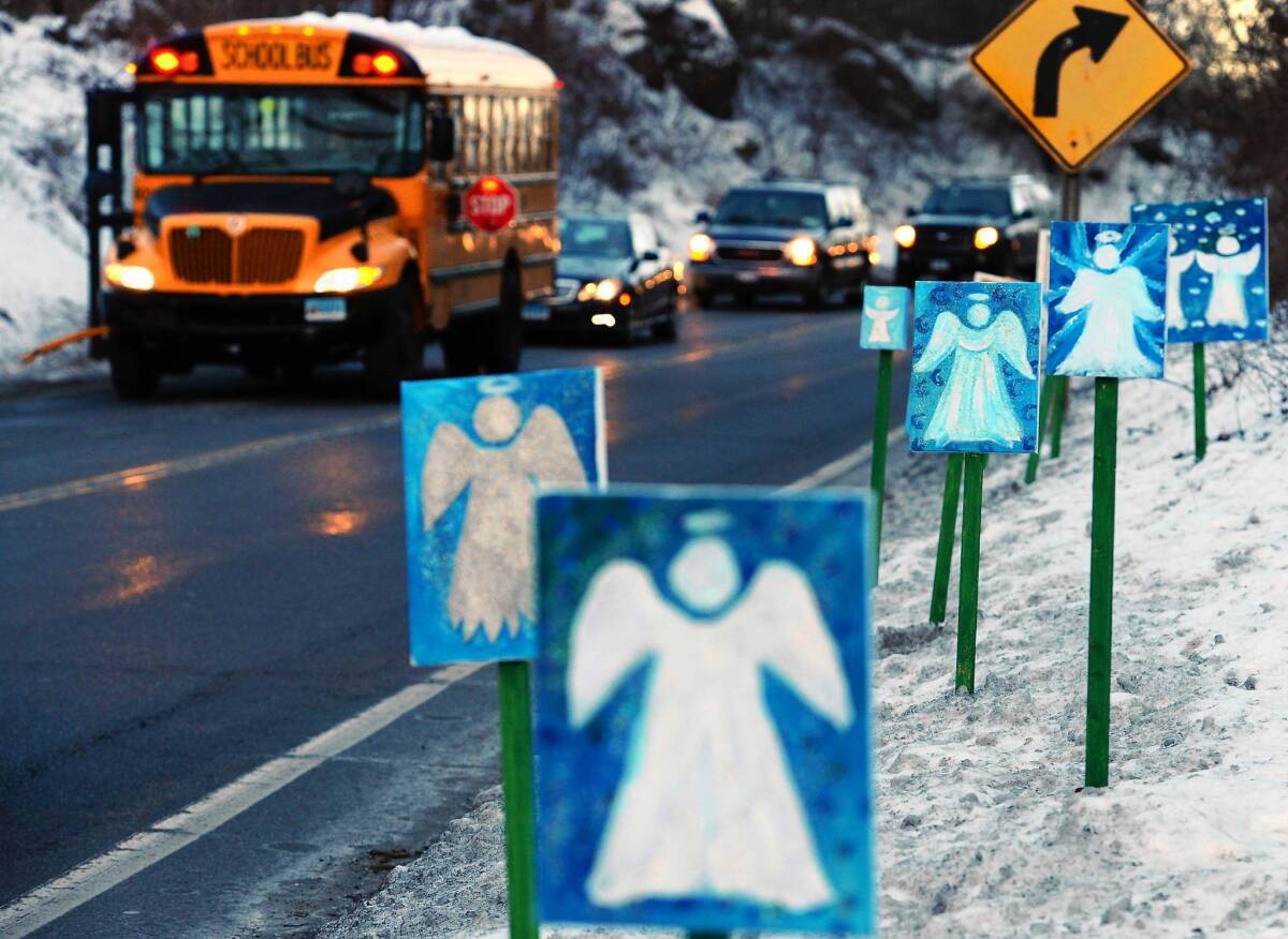 A bus traveling from Newtown, Conn., to nearby Monroe passes 26 angels representing those killed at Sandy Hook Elementary School.