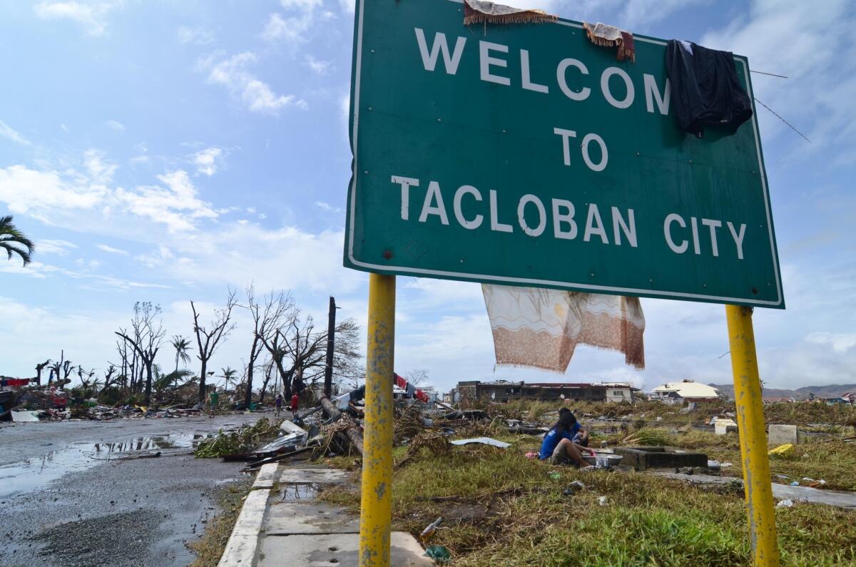 In the Philippine city of Tacloban, residents wash their clothes in a canal after typhoon Haiyan.