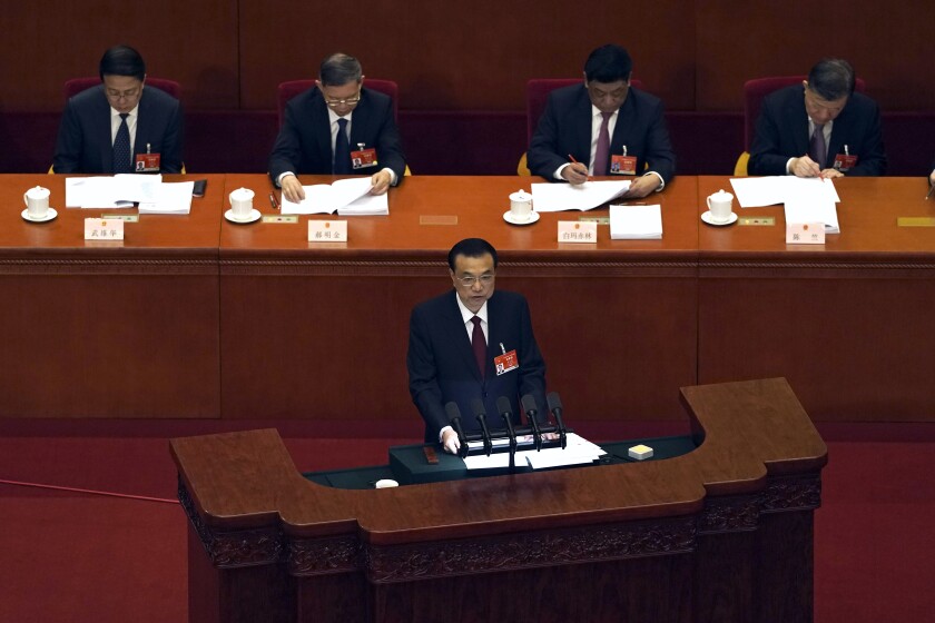 Chinese Premier Li Keqiang delivers a speech during the opening session of China's National People's Congress (NPC) at the Great Hall of the People in Beijing, Friday, March 5, 2021. (AP Photo/Andy Wong)
