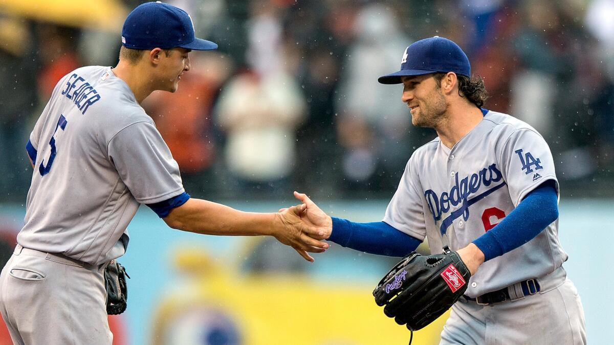 Charlie Culberson (6) and Corey Seager (5) celebrate after the Dodgers defeated the Giants in 10 innings Saturday.