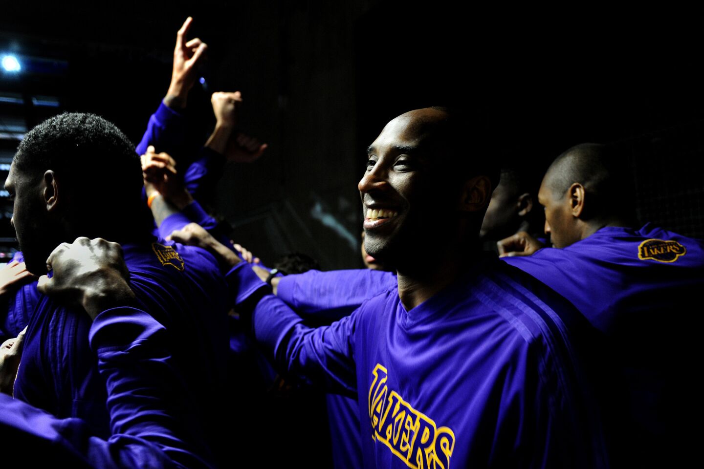 Kobe Bryant laughs as he joins the huddle before taking the court against the host Pelicans.