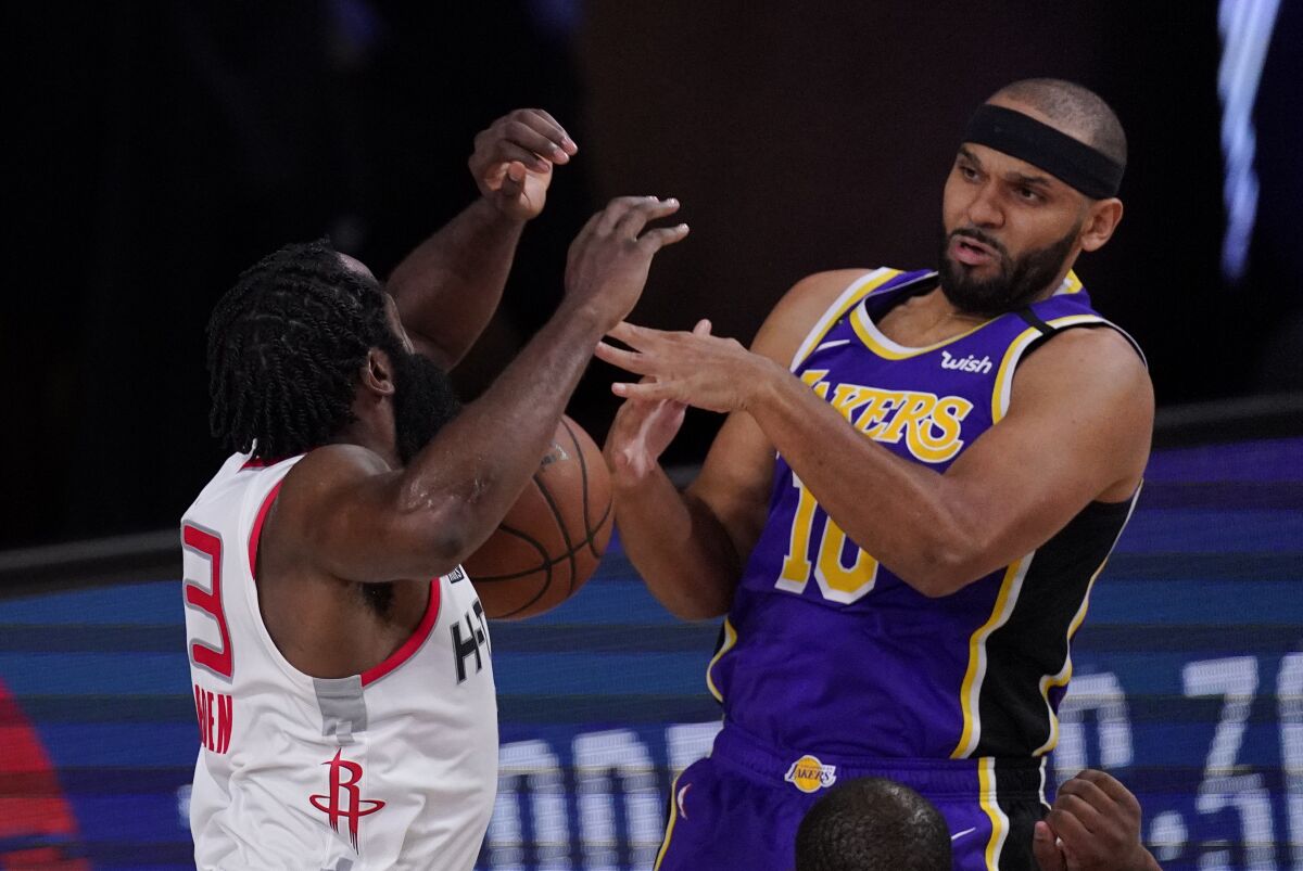 Houston Rockets' James Harden (13) fights for a rebound with Los Angeles Lakers' Jared Dudley (10) during the second half of an NBA conference semifinal playoff basketball game Friday, Sept. 4, 2020, in Lake Buena Vista, Fla. The Rockets won 112-97. (AP Photo/Mark J. Terrill)