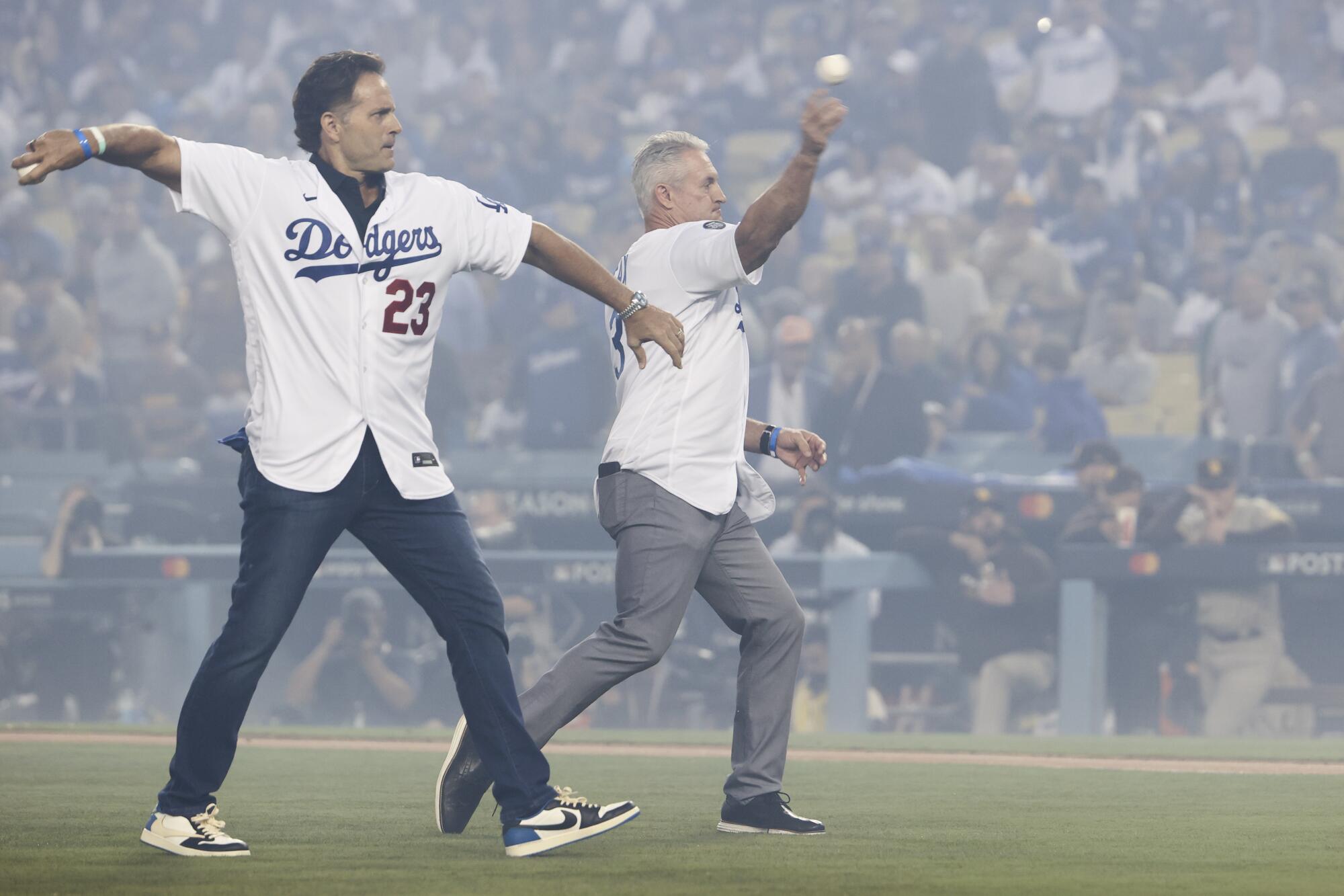Eric Karros, left, and Steve Sax throw out to ceremonial first pitch before Game 1 of the 2022 NLDS at Dodger Stadium.