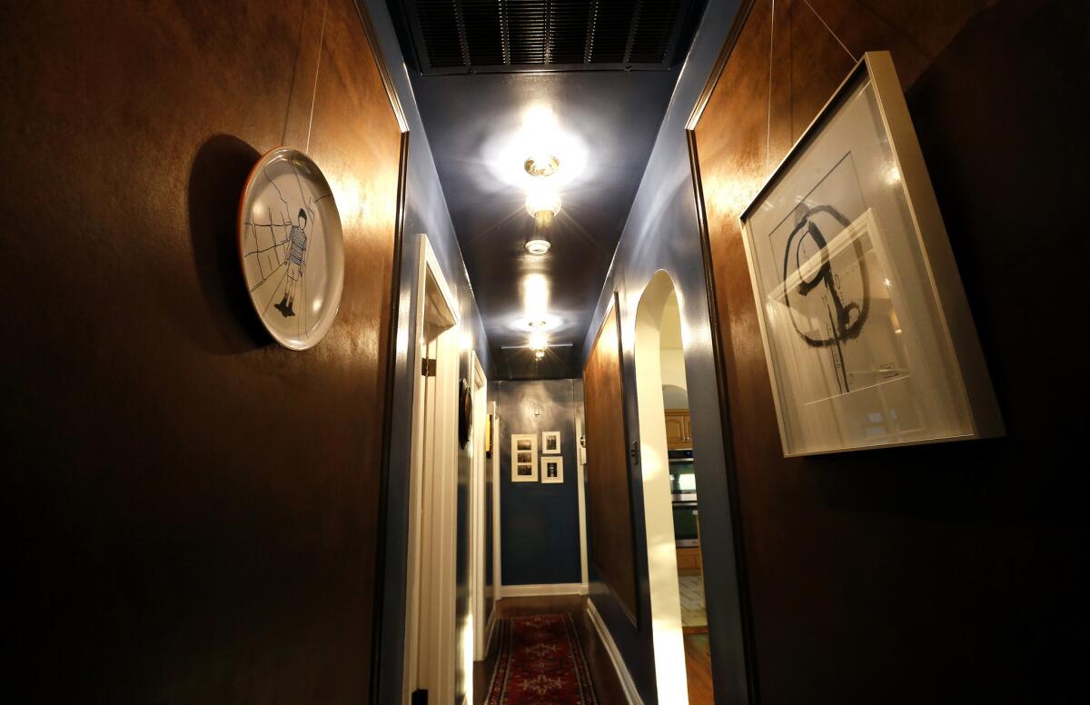 Picture rails with sueded leather paper wall covering are featured in the hallway. (Mel Melcon / Los Angeles Times)