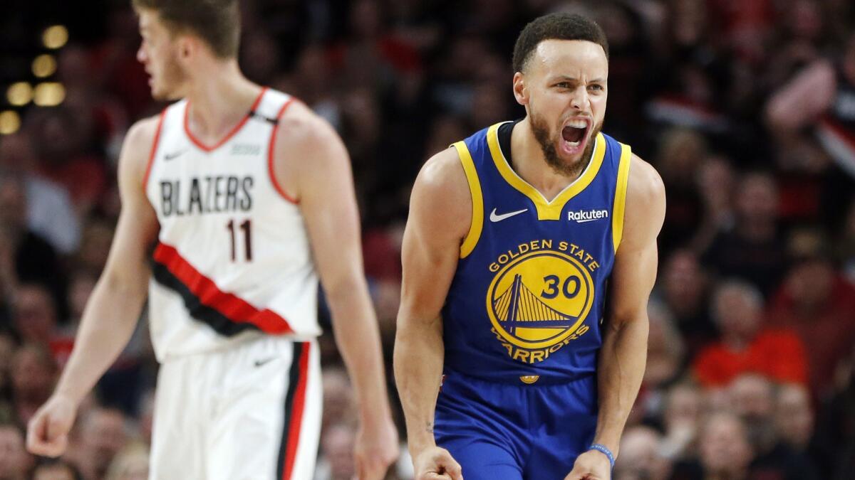 Stephen Curry celebrates during the second half of the Golden State Warriors' win over the Portland Trail Blazers in Game 3 of the Western Conference finals on May 18.
