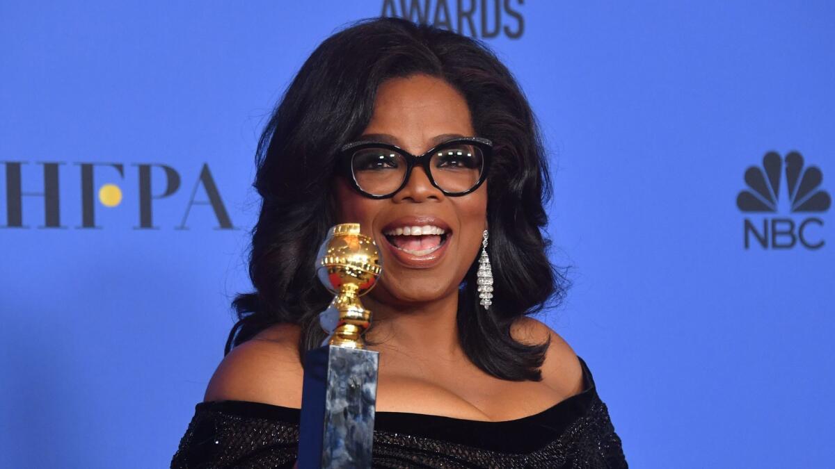 Actress and TV talk show host Oprah Winfrey displays the Cecil B. DeMille Award during the 75th Golden Globe Awards.