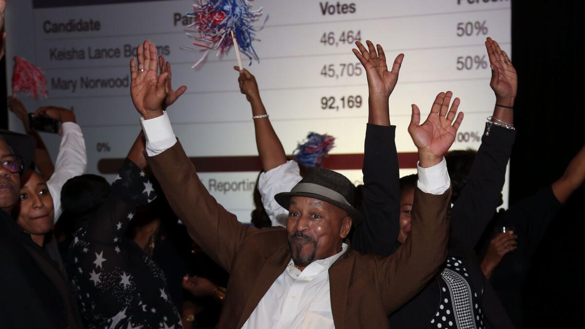Supporters of Atlanta mayoral candidate Keisha Lance Bottoms celebrate during an election night watch party. Bottoms narrowly won the initially tally; a recount might take several days to complete.