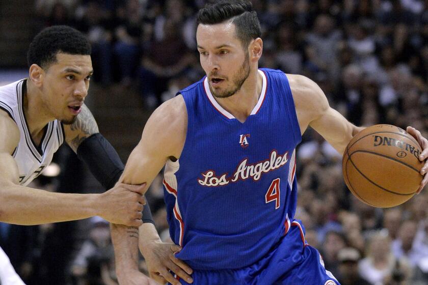 Clippers shooting guard J.J. Redick drives against Spurs guard Danny Green during the first half of Game 6.