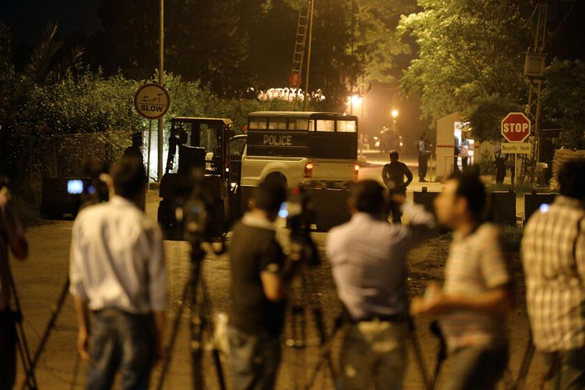 Police stand guard and journalists gather outside the residence of former Pakistani President Pervez Musharraf in Islamabad, the capital.