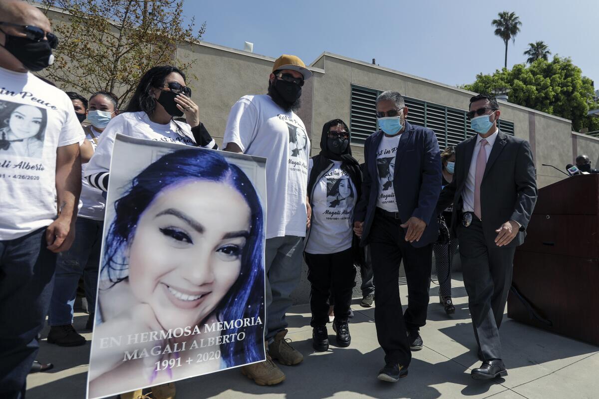 Family members of shooting victim Magali Alberto attend an LAPD news conference.