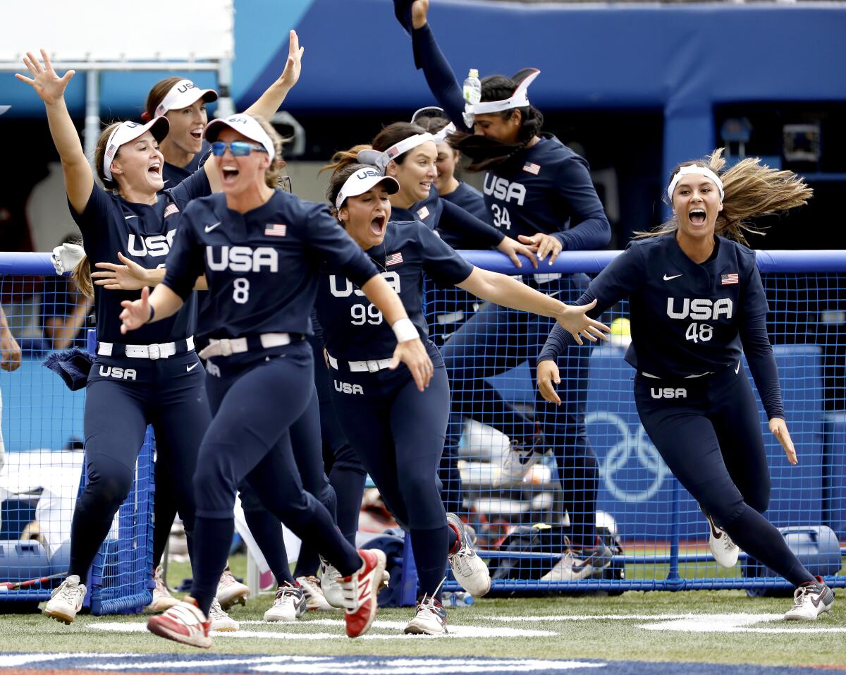 U.S. softball players celebrate after Kelsey Stewart's walk-off homer to right field to cap a 2-1 win over Japan.