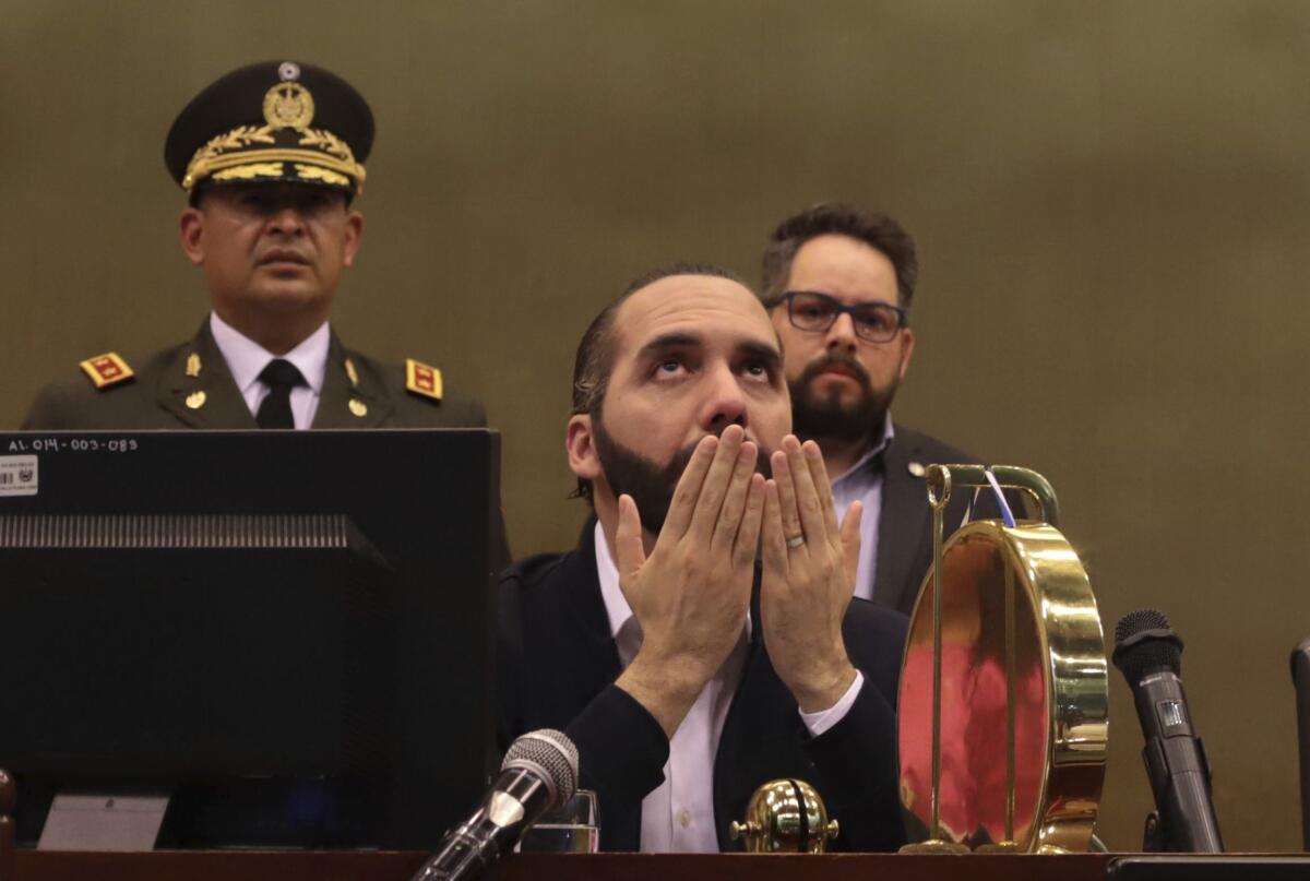 President Nayib Bukele with his hands open in front of his face and his eyes cast upward
