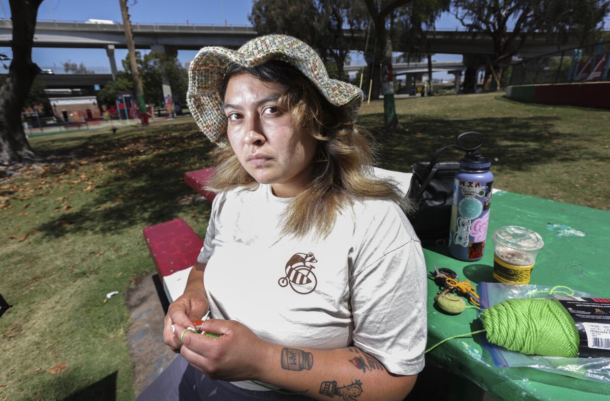 Maritza Garcia crochets in Chicano Park on Tuesday, May 4, 2021 in San Diego, CA.