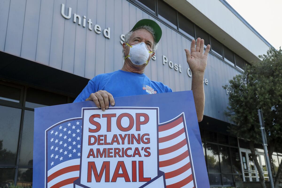 Paul Shevlin, a USPS employee, demonstrates against Postmaster General Louis DeJoy's service changes