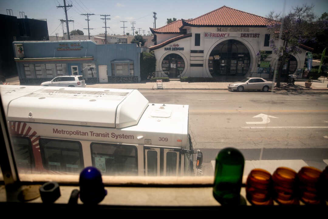 The number 7 bus passes by as seen from the upstairs at San Diego Electric store.