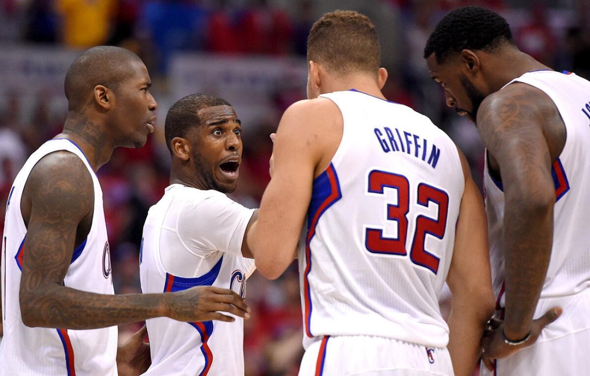 Clippers points guard Chris Paul, second from left, talks with teammates (from left) Jamal Crawford, Blake Griffin and DeAndre Jordan in the second half of Game 1 against the Warriors on Saturday at Staples Center.