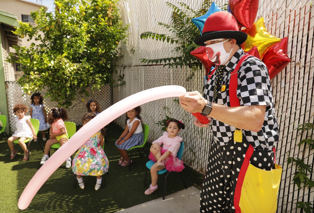 Guilford Adams makes balloon animals for children.