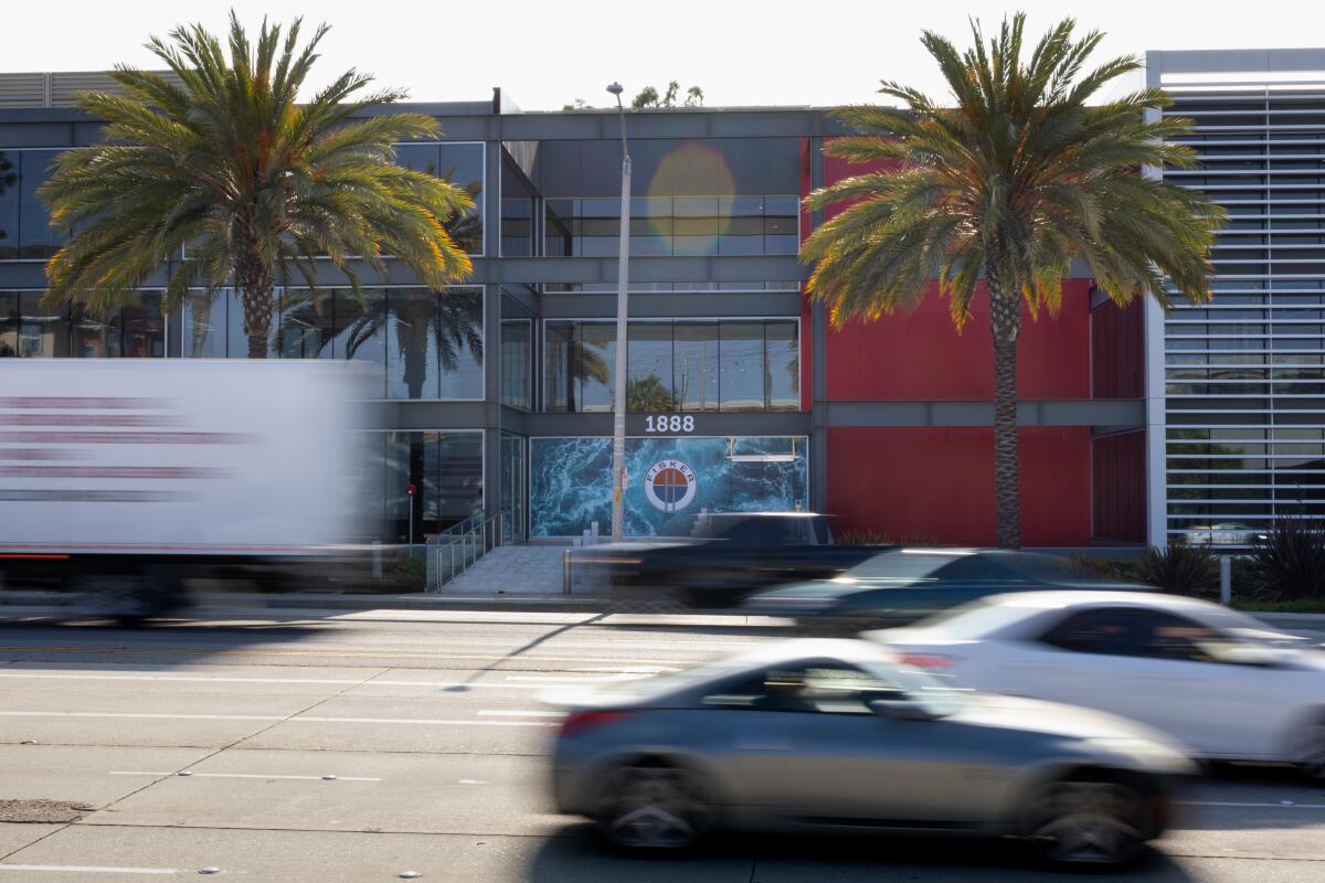 Cars blur in front of the Manhattan Beach, CA headquarters of electric-vehicle maker Fisker Inc. in May.