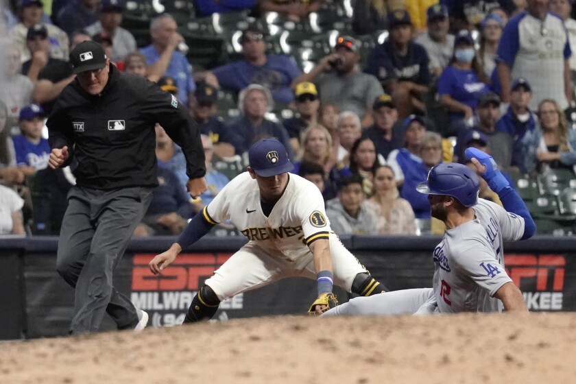 Dodgers' Joey Gallo gets tagged at third base by Milwaukee Brewers' Luis Urías.