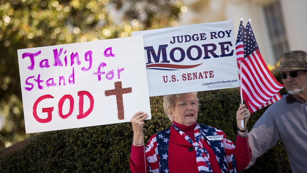 A woman attends a rally for Roy Moore in Montgomery, Ala., on Friday.
