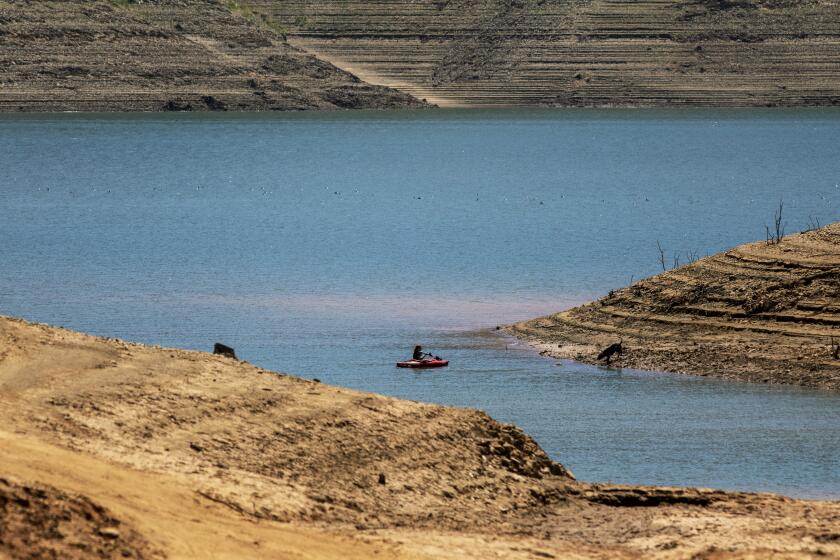 OROVILLE, CA - JUNE 29: A kayaker on the water at Lake Oroville, which stands at 33 percent full and 40 percent of historical average when this photograph was taken on Tuesday, June 29, 2021 in Oroville, CA. (Brian van der Brug / Los Angeles Times)