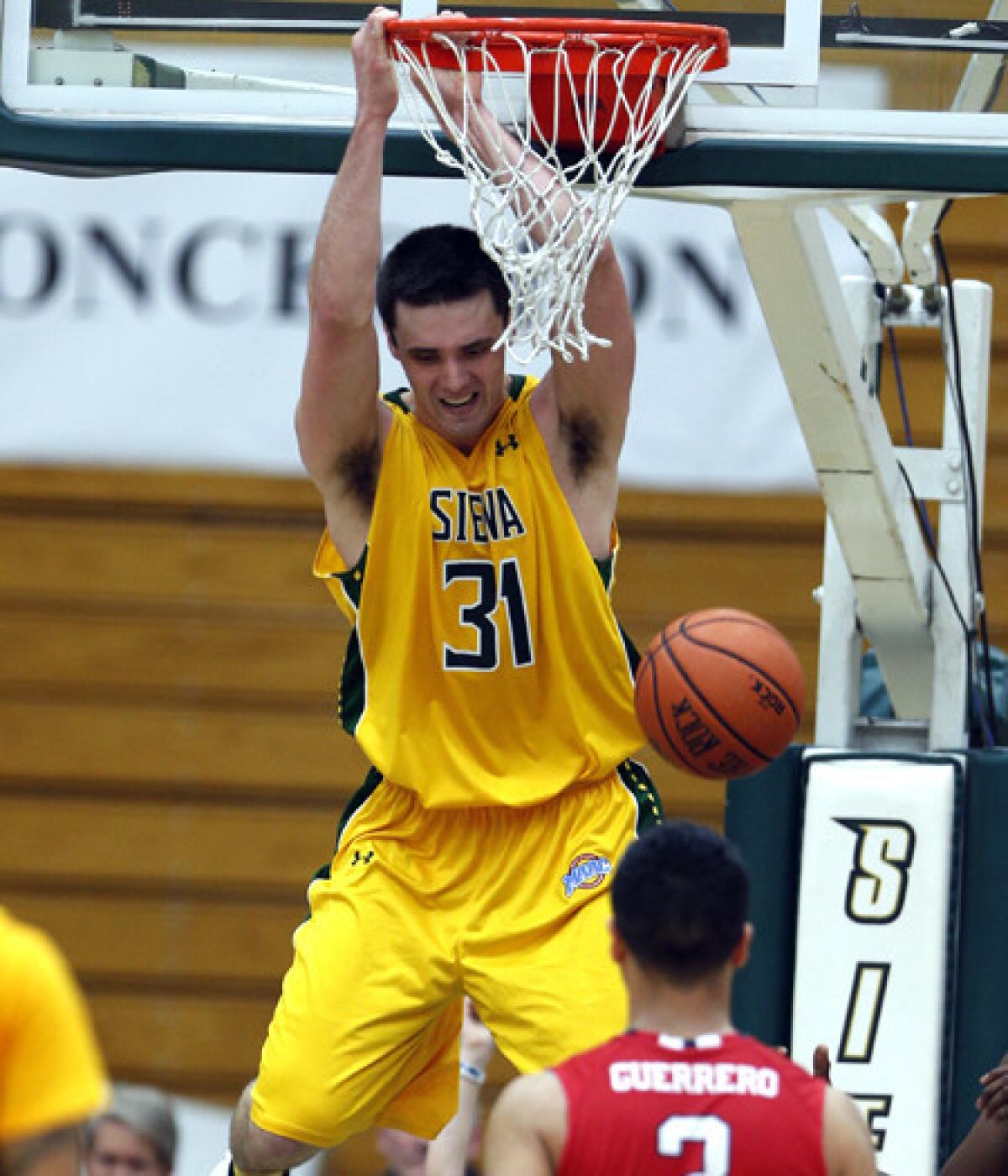 Siena's Brett Bisping, shown dunking during Game 2 of the CBI championship series, had 20 points and nine rebounds in the deciding game Saturday.
