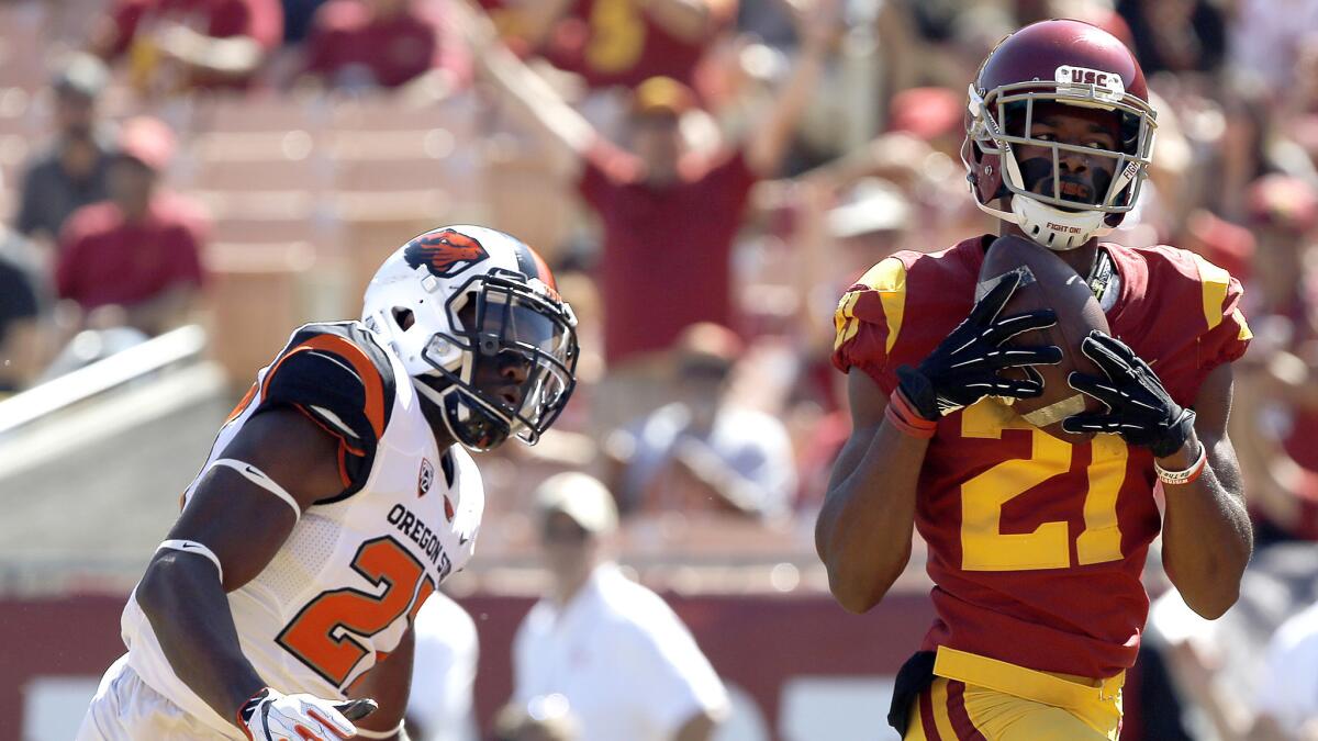 USC wide receiver Tyler Vaughns hauls in a touchdown pass against Oregon State cornerback Kyle White during the first half of Saturday's game. USC won 38-10.