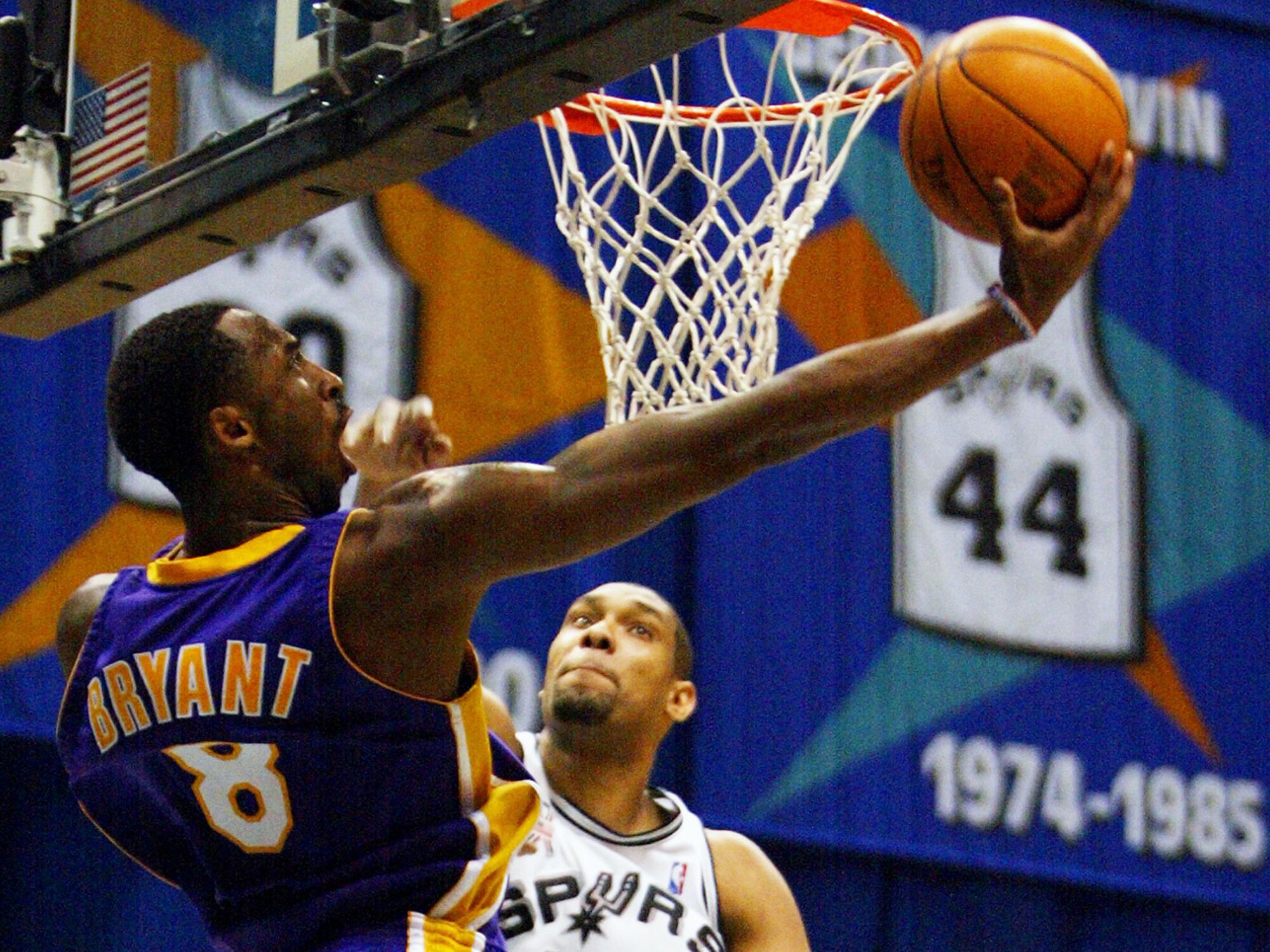 Kobe Bryant attempts a reverse layup against Spurs forward Tim Duncan during the 2002 playoffs.